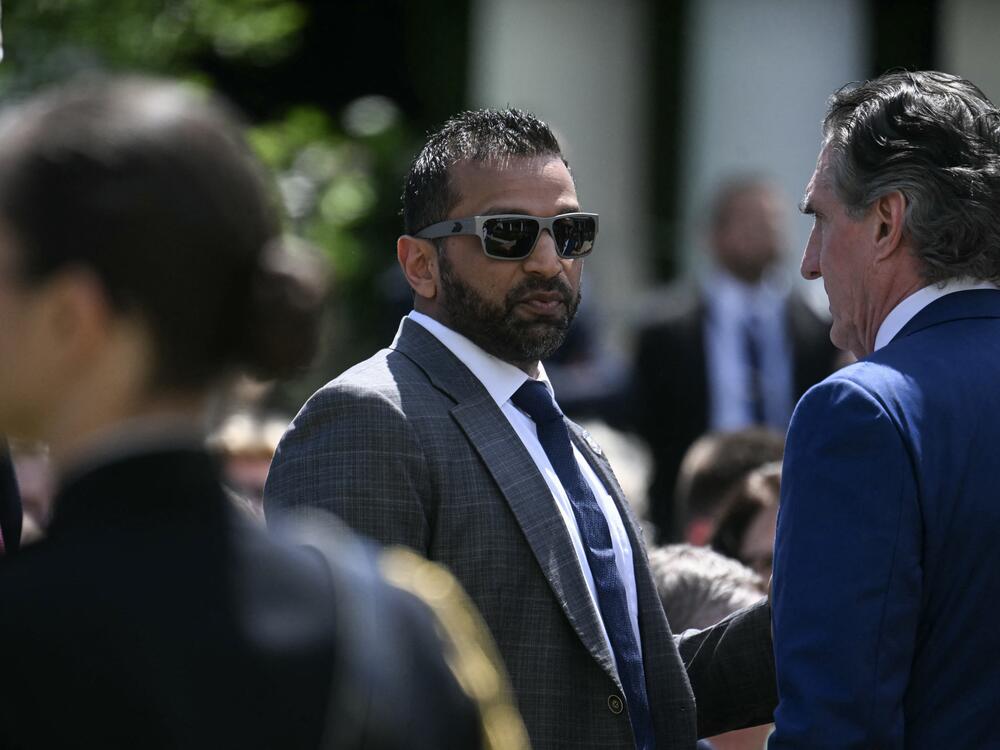 FBI Director Kash Patel speaks with Secretary of the Interior Doug Burgum last month.