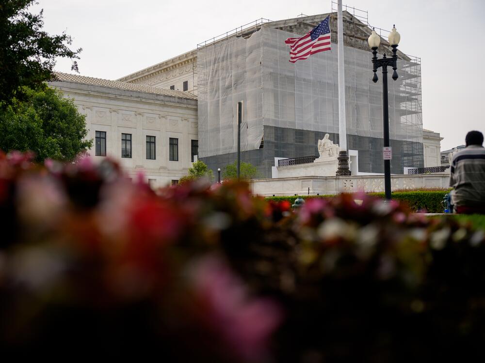 A person rests in front of the U.S. Supreme Court on June 5 in Washington, D.C.