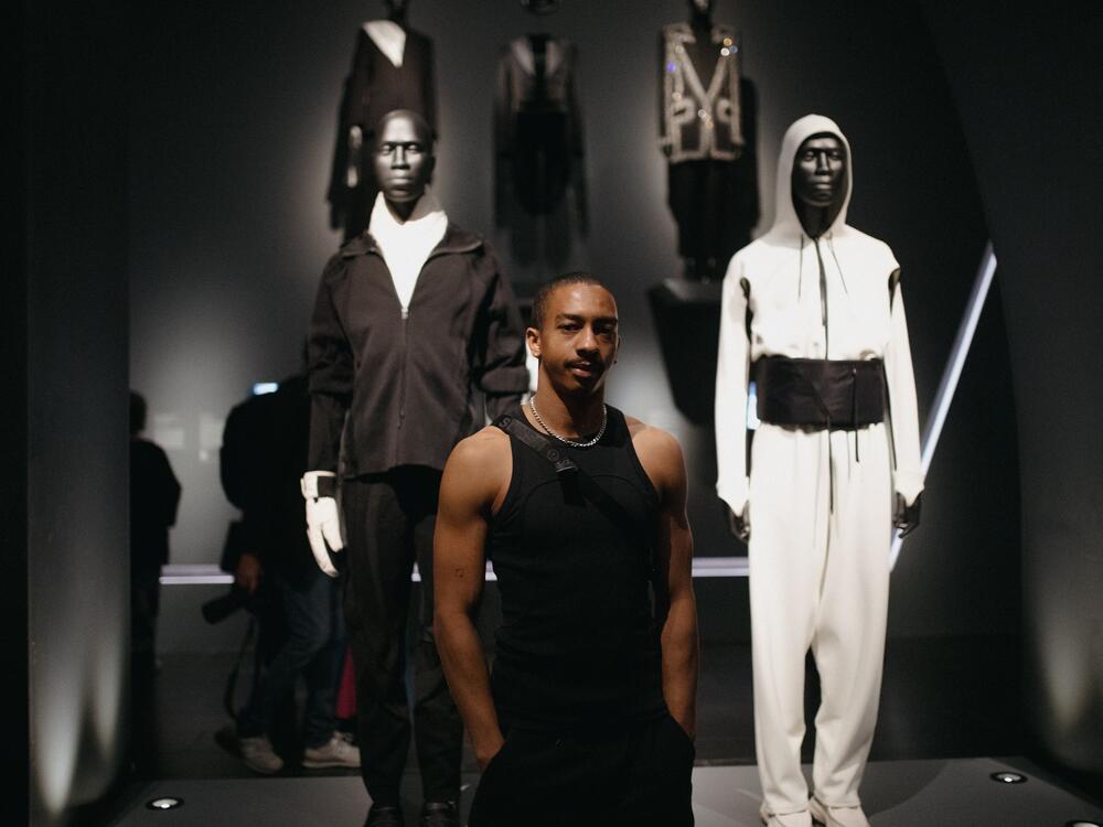 Designer Saul Nash stands in front of his pieces during a press preview.
