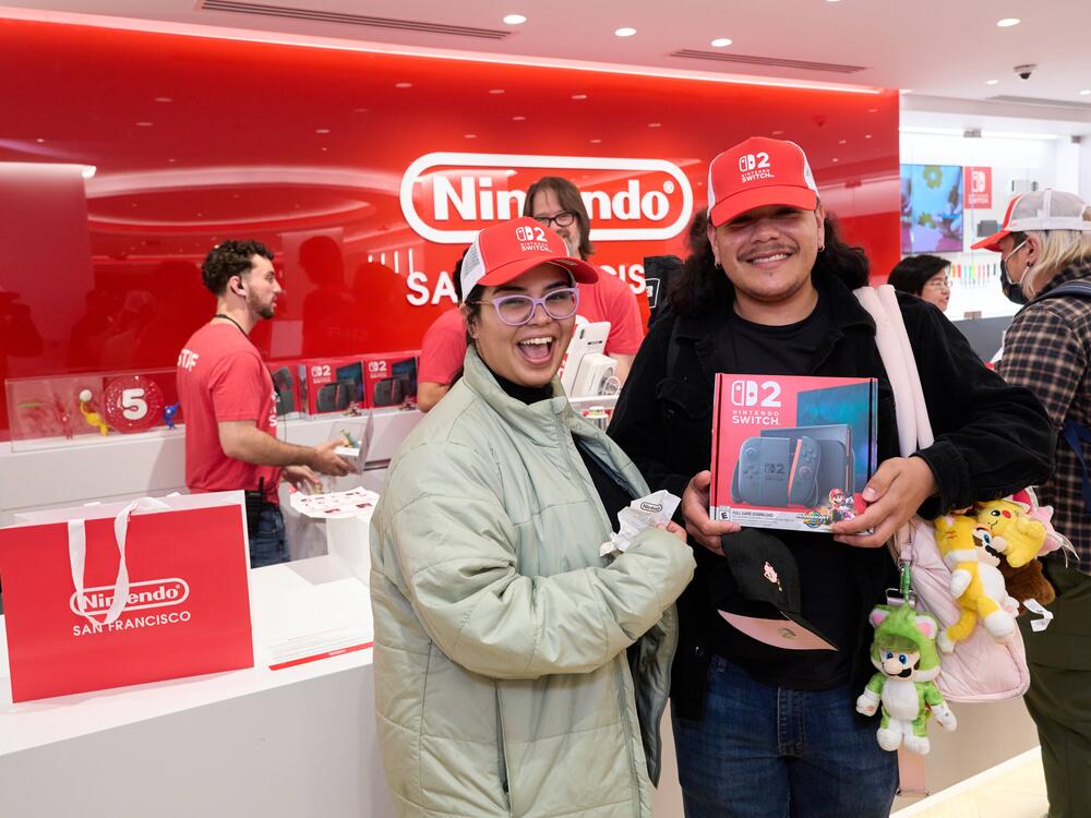 Fans pose with Nintendo Switch 2 systems at a new Nintendo store in San Francisco.
