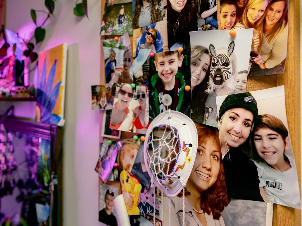 Photos of family members, including Becca Morris' son, Jayden, decorate a bulletin board in her bedroom.