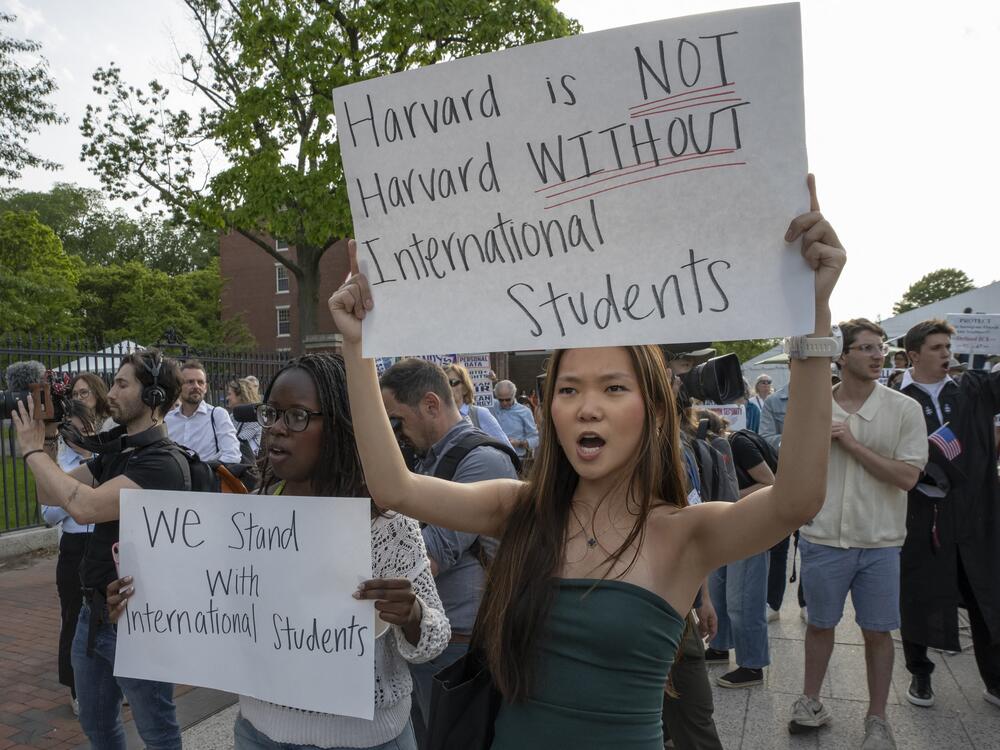 People hold up signs during the Harvard Students for Freedom rally in support of international students at the Harvard University campus in Boston on May 27.