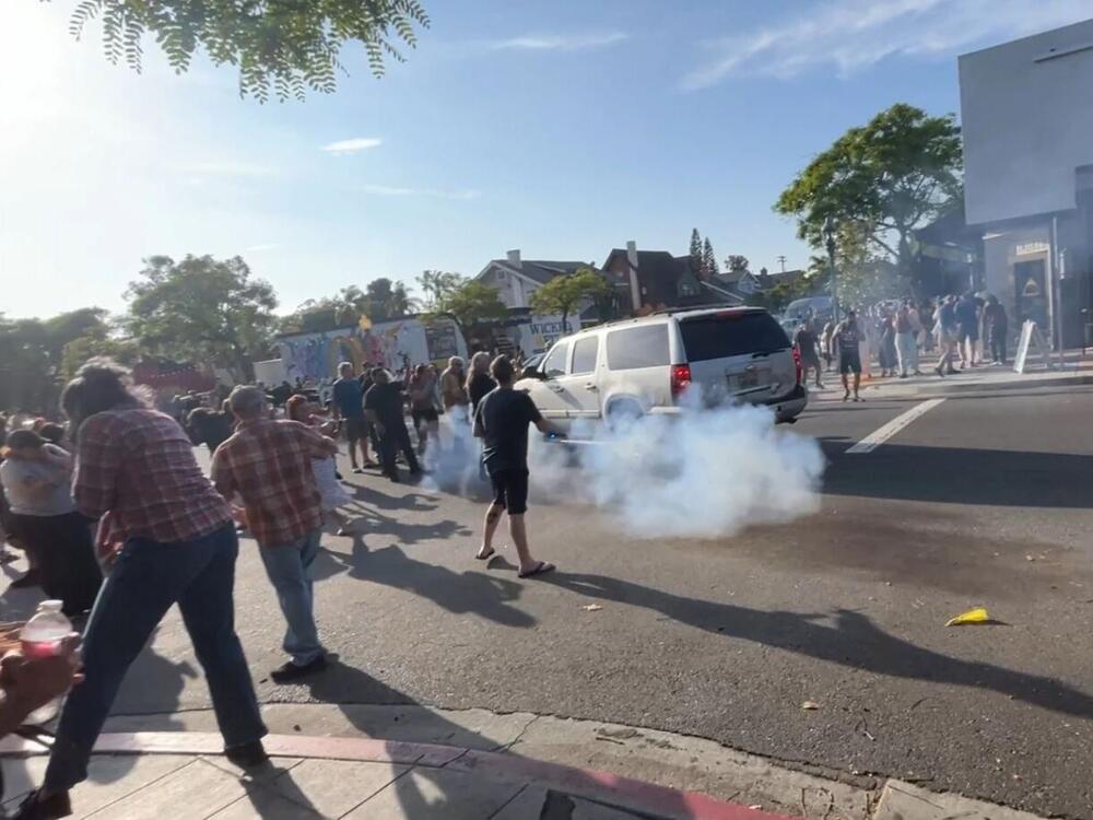 ICE agents used what appeared to be a smoke device to disperse the crowd near Buona Forchetta in San Diego, Calif., on May 30, 2025.