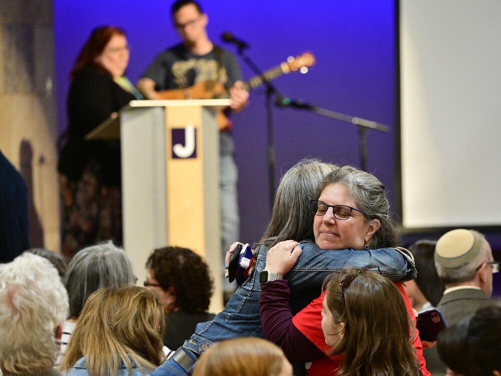 Women embrace before a community vigil at the Boulder Jewish Community Center to mark an attack in Boulder, Colo., Wednesday, June 4, 2025.