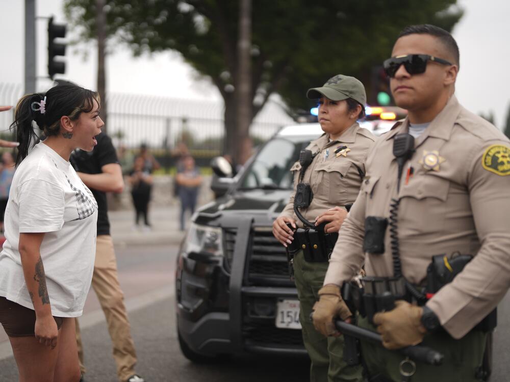 Protesters confront law enforcement agents outside an industrial park in Paramount, Calif., on Saturday, June 7.