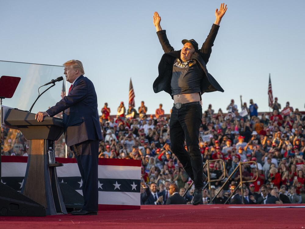 Musk jumps on stage to join Trump during a campaign rally at site of Trump's assassination attempt in Butler, Pa. on Oct. 5, 2024.
