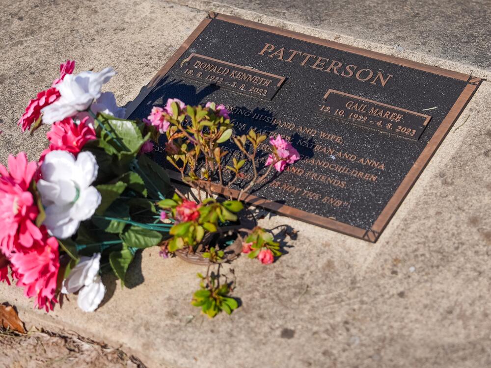 Flowers rest on the grave site for Don and Gail Patterson at the Korumburra General Cemetery during their daughter-in-law's trial in May 2025.