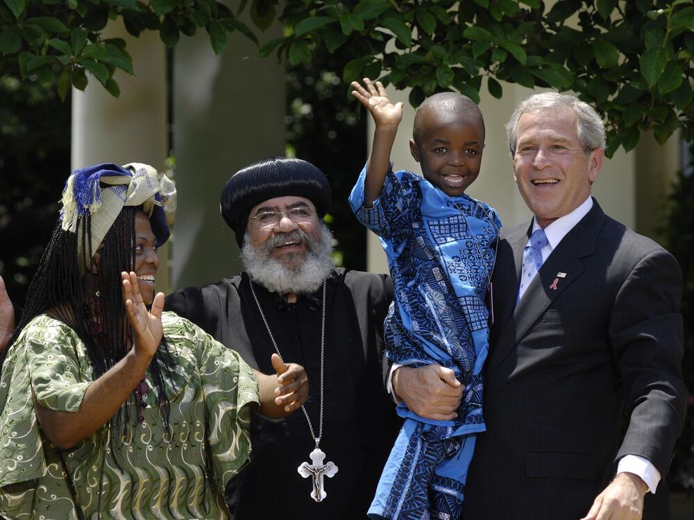 In this 2007 photograph, President George W. Bush holds Baron Mosima Loyiso Tantoh, 4, whose mother Kunene Tantoh, left, is HIV positive and who worked with a program for mothers with HIV in Cape Town that was supported by U.S. funds. At that time, Bush was asking Congress to approve $30 billion over the next five years for PEPFAR, the program that he'd established in 2003 to combat the spread of AIDS.