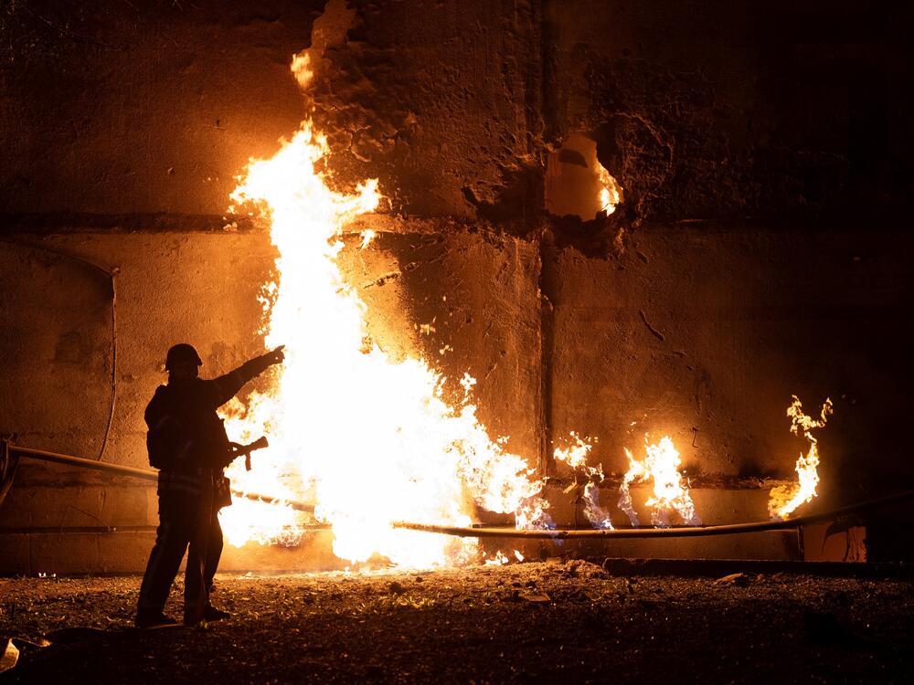 A Ukrainian firefighter responds to a drone strike in the northeastern city of Kharkiv on Thursday. Both sides have ramped up drone attacks. Russia has fired more than 400 drones at Ukraine on two separate nights in the past week, the largest numbers in the war.