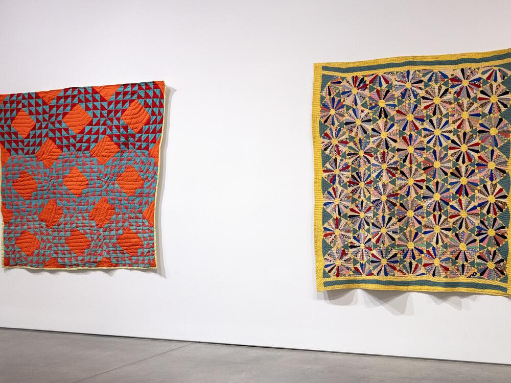 Quilts on display at BAMPFA. [Left] Beauty Earnestine Vaughns, <em>Untitled (Ocean Wave); </em>Bequest of the Eli Leon Living Trust, BAMPFA; Courtesy of Douglas Washington, grandson of the quiltmaker; [Right] Pearl Nunley and Beauty Earnestine Vaughns, <em>Flower Garden (Sunflower Variation); </em>Bequest of the Eli Leon Living Trust, BAMPFA‬; Courtesy the Descendants of Pearl Nunley.<br>