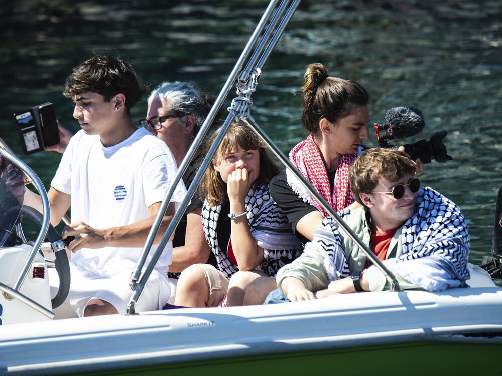 Climate activist Greta Thunberg, center, waits to board the Madleen boat, before setting sail for Gaza along with activists of the Freedom Flotilla Coalition, departing from the Sicilian port of Catania, Italy, Sunday, June 1, 2025.