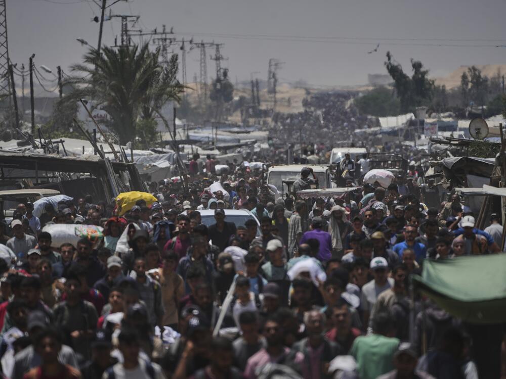 Palestinians carry bags containing food and humanitarian aid packages delivered by the Gaza Humanitarian Foundation, a U.S.-backed organization, in Rafah, southern Gaza Strip, Sunday, June 8, 2025.