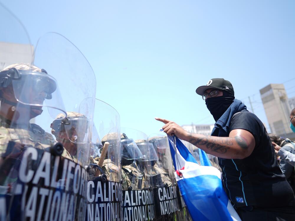 A protester confronts a line of California National Guard in the metropolitan detention center of downtown Los Angeles on Sunday.