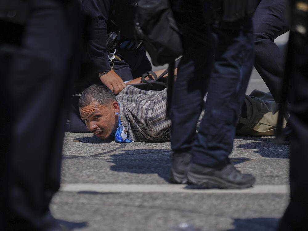 A protester is detained by police in downtown Los Angeles.
