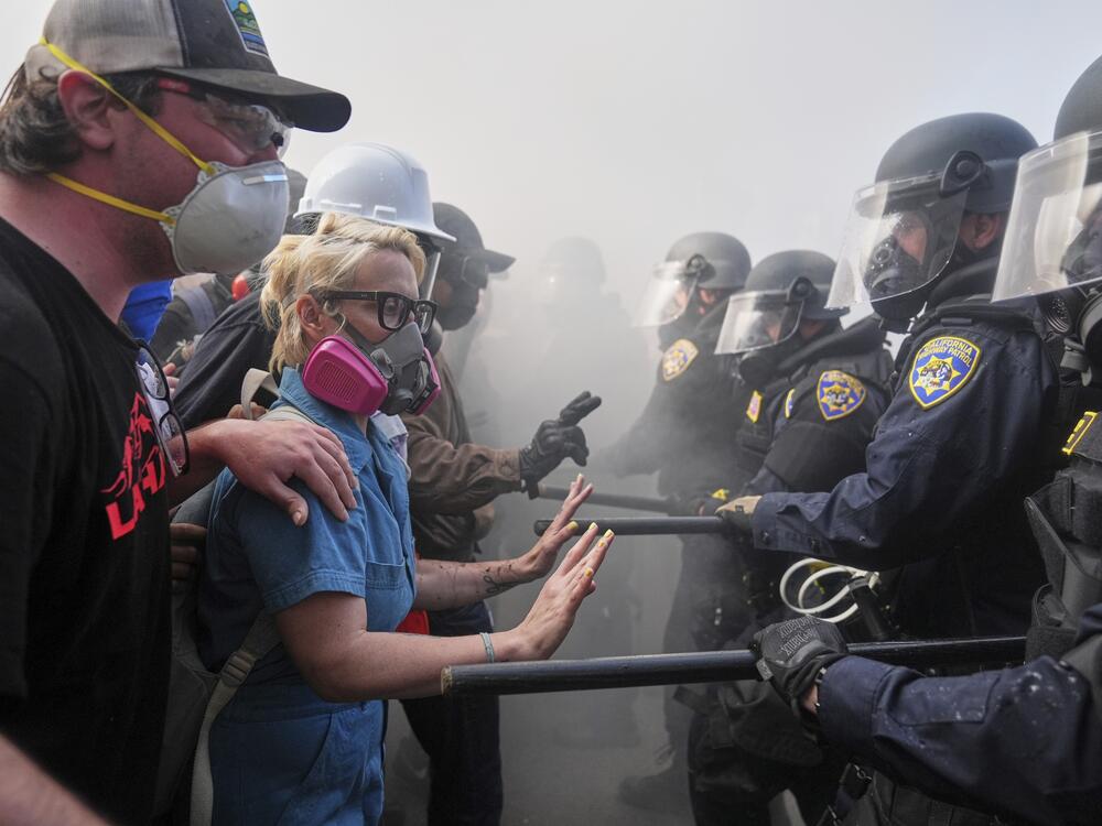 Protesters confront police on the 101 Freeway near the Metropolitan Detention Center of downtown Los Angeles.