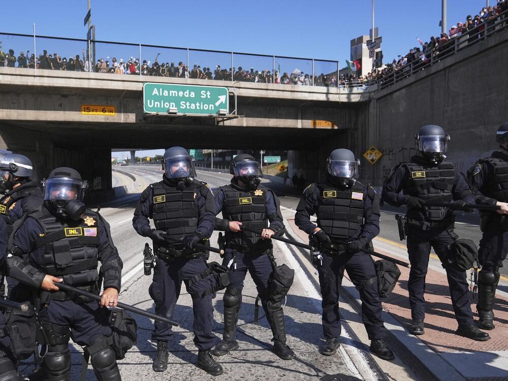 Police are lined up on the 101 freeway near the Metropolitan Detention Center of downtown Los Angeles.
