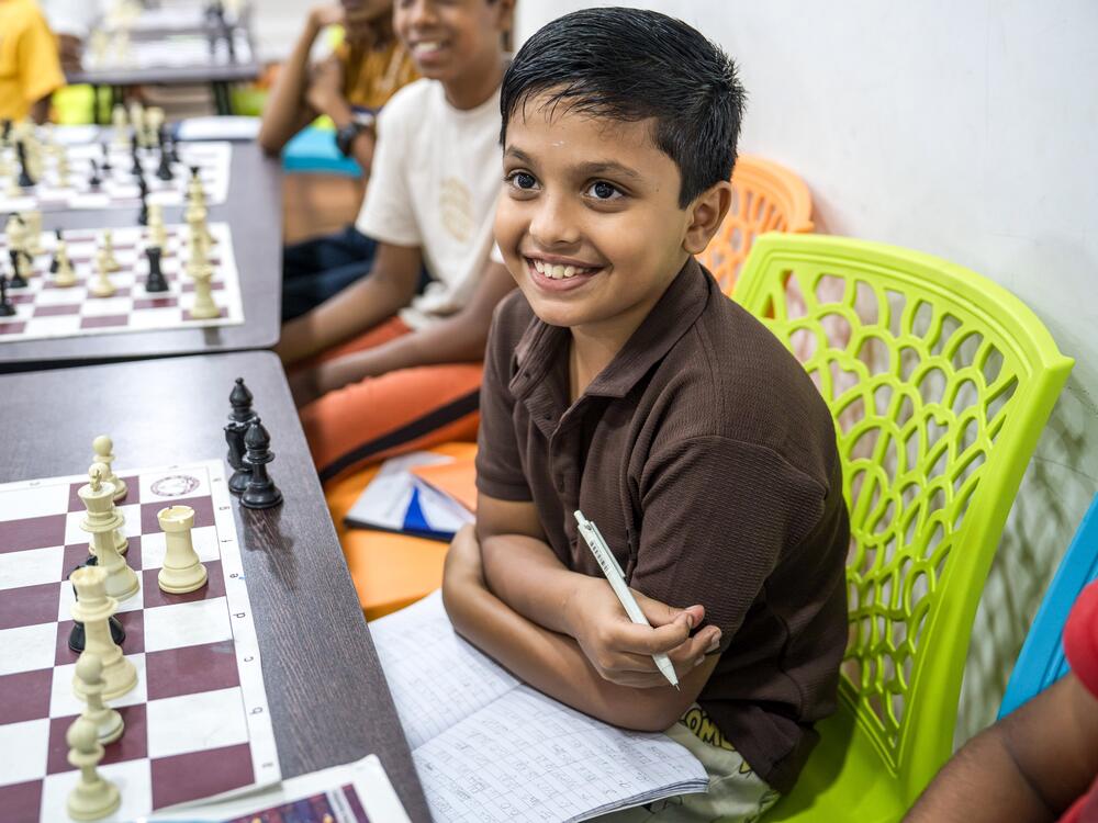 Ten-year-old Keashaanth, with a notebook and chessboard in front of him, follows along as his coach Selvabharathy leads a class at the Madras School of Chess in Chenna.