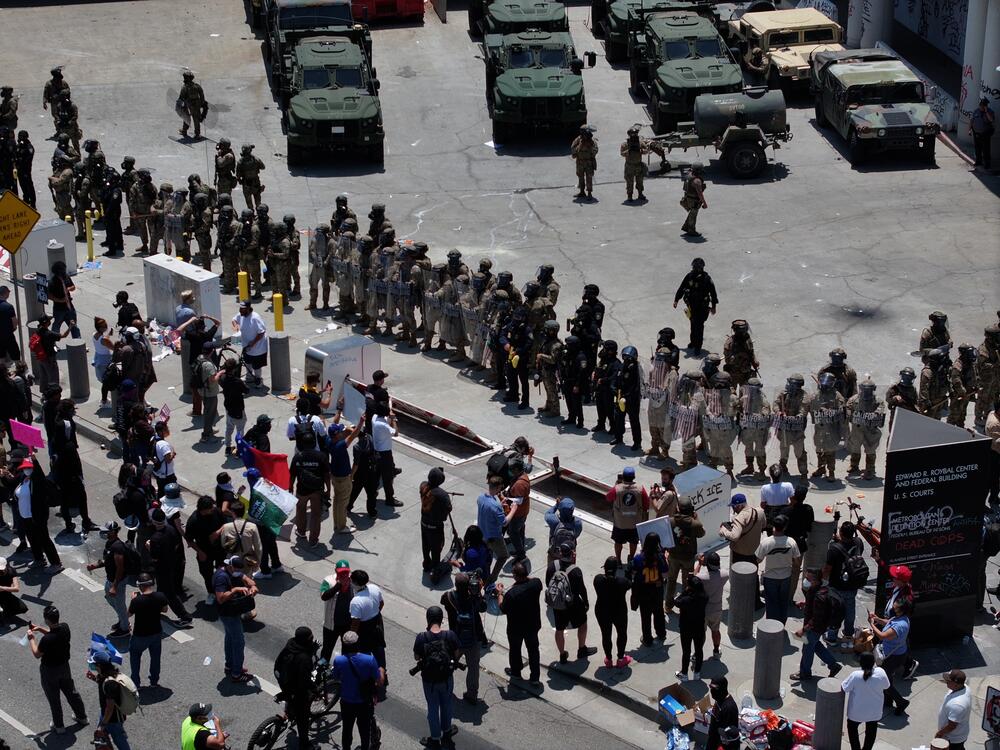 ICE officers and the National Guard confront protesters outside of the Metropolitan Detention Center in Los Angeles.