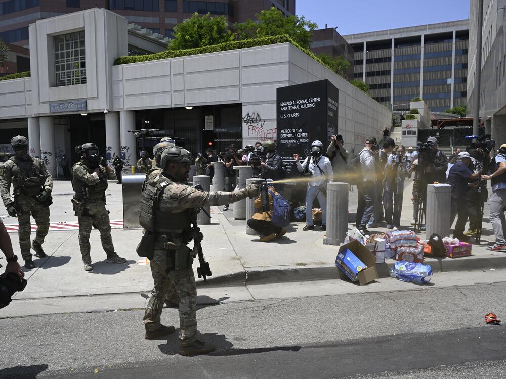 ICE officers and members of the National Guard confront protesters outside of the Metropolitan Detention Center in Los Angeles.