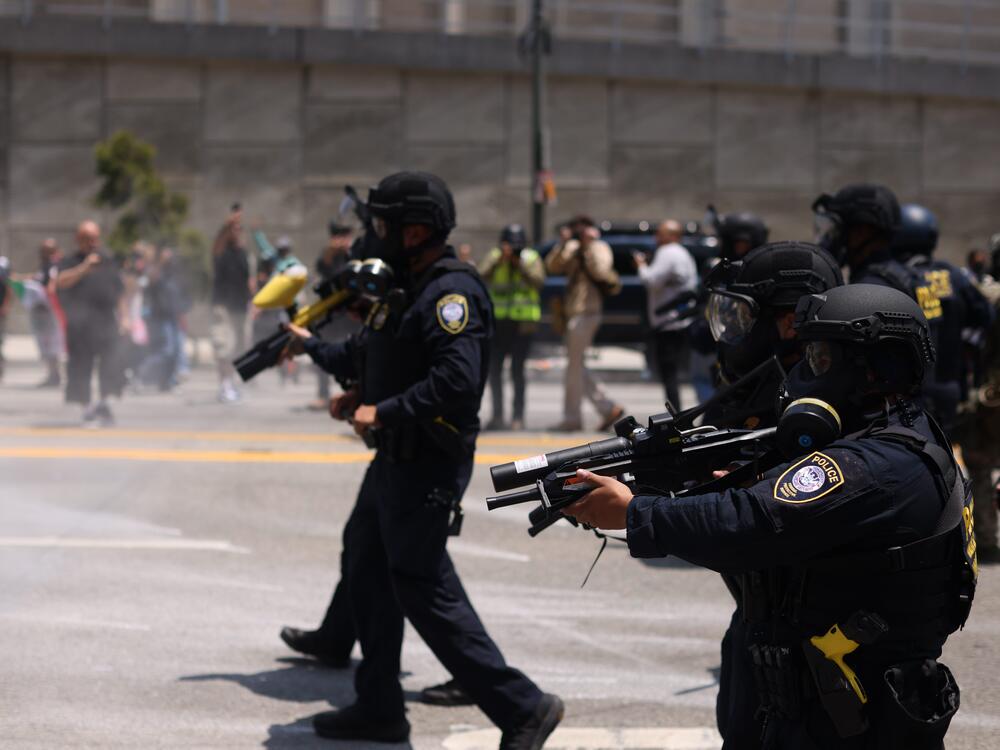 Immigration and Customs Enforcement (ICE) and Department of Homeland Security (DHS) agents take security measures as protests and confrontations between immigration rights supporters and law enforcement continue in Paramount, California, and downtown Los Angeles..