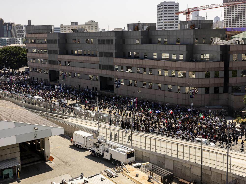 Law enforcement clash with demonstrators in front of a federal building during a protest in Los Angeles on Sunday.