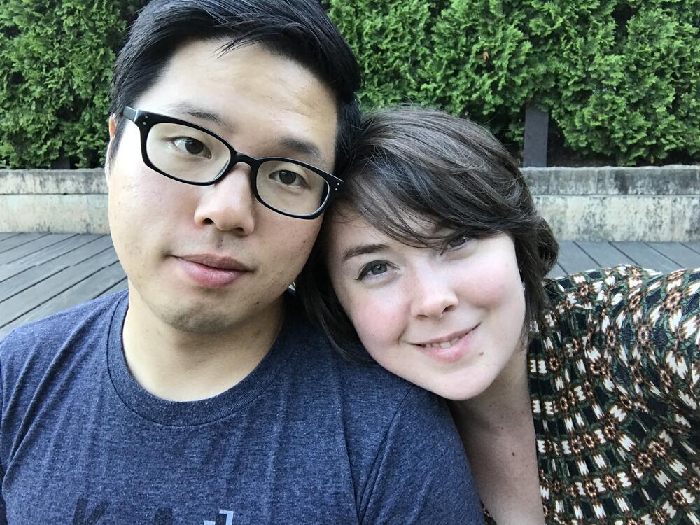 Ayla Ludwig smiles at the camera as she rests her head on her husband's shoulder.
