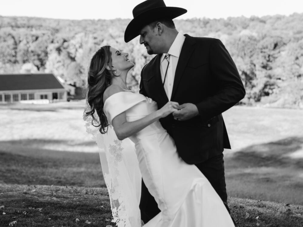 Nina and Daniel Solis look into each other's eyes and smile as they embrace.