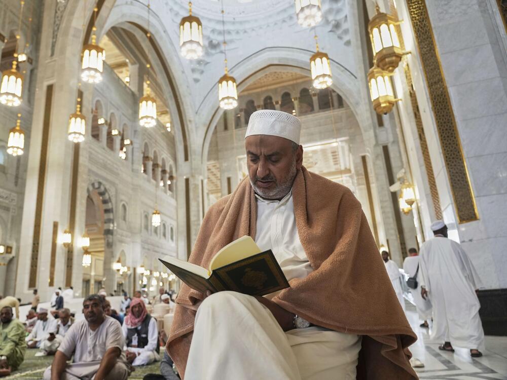 A Muslim pilgrim reads a copy of the Quran at the Grand Mosque during the annual Hajj pilgrimage in Mecca, Saudi Arabia.