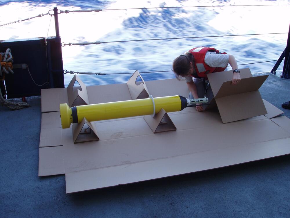 Deploying a float without stopping the ship requires special boxes to protect the floats. Here cross braces are assembled to protect the antenna on the RV Melville.