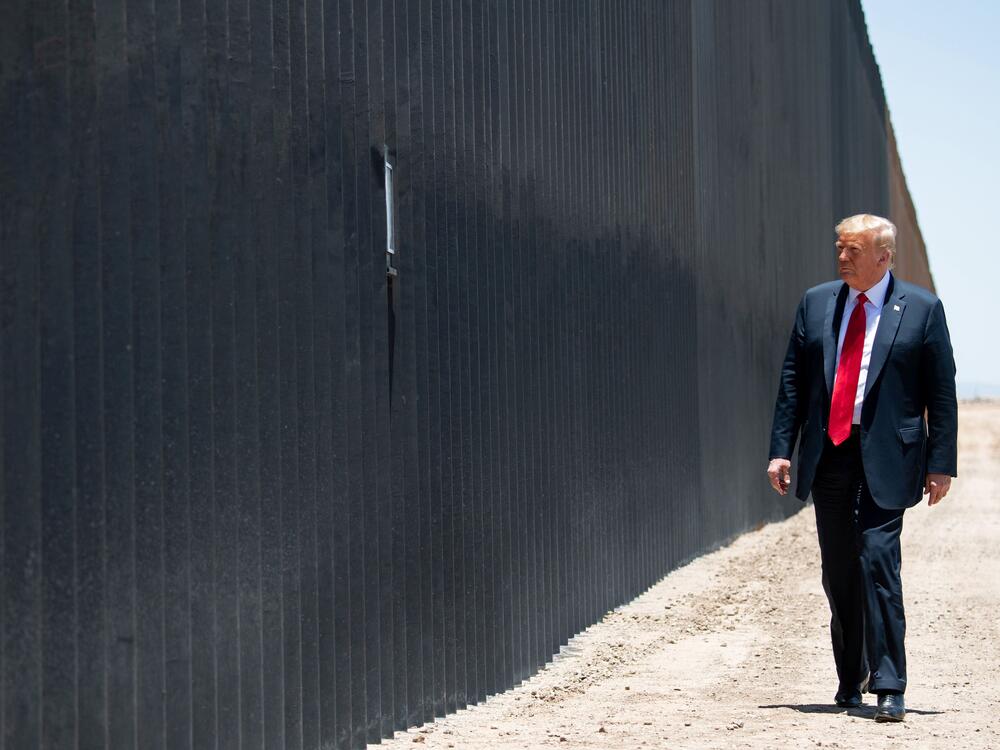 Trump participates in a ceremony commemorating the 200th mile of border wall at the international border with Mexico in San Luis, Ariz., in 2020. He declared a national emergency to help fund the wall.