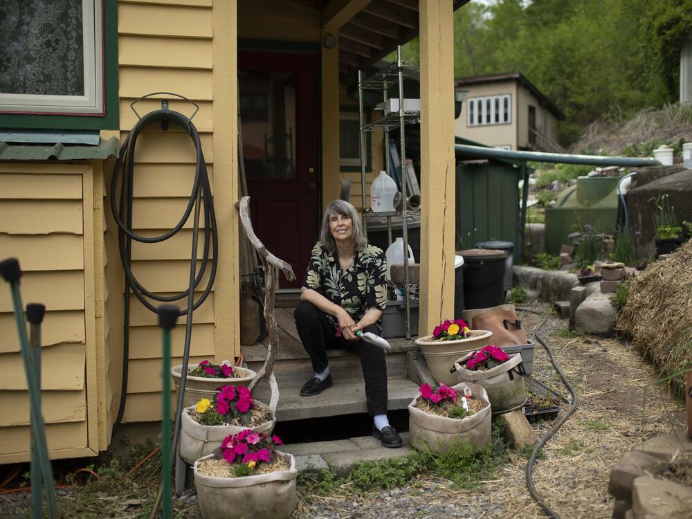 Earthavener Diane Leafe Christian sits on the porch at her home in the ecovillage. 