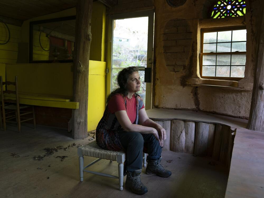 Amy Belanger sits inside her Earthaven home, which is known as 