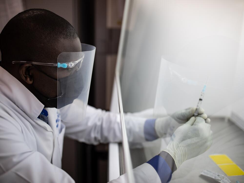 A vaccine pharmacist prepares samples as part of an HIV vaccine trial on March 16, 2022 in Masaka, Uganda. The vaccine in that trial did not prove effective. A promising vaccine development program funded by the National Institutes of Health was just informed by the Trump administration that its support will end next year.