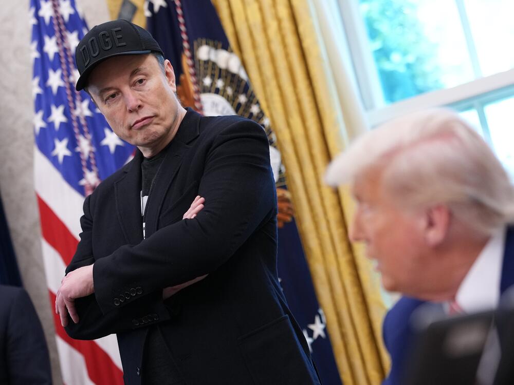 Elon Musk listens as President Trump speaks to reporters in the Oval Office on May 30. A week after the two traded social media disses and threats, Musk said Wednesday some of his posts 