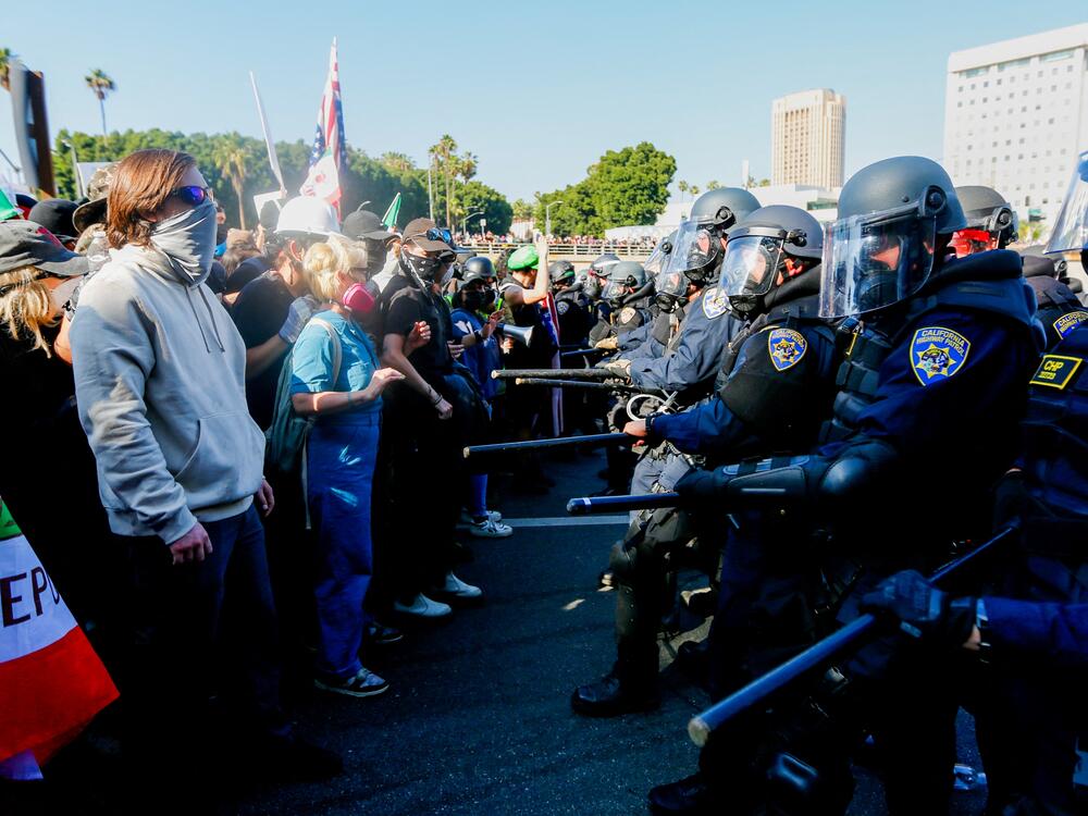 California Highway Patrol officers attempt to control crowds on the 101 Freeway during an anti-ICE protest in downtown Los Angeles on Sunday. Protests erupted after a wave of federal immigration raids began around the city, with National Guard troops deployed despite objections from local officials.