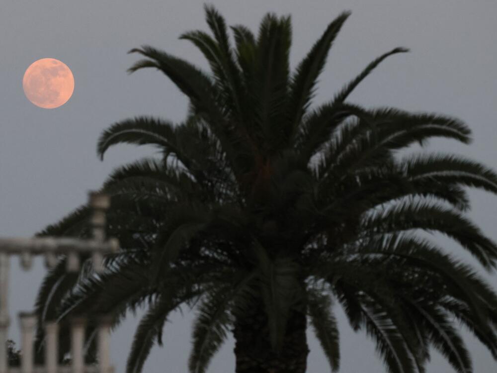 A picture shows the moon over Kibbutz Kfar Aza in southern Israel near the Gaza border on June 10, 2025.