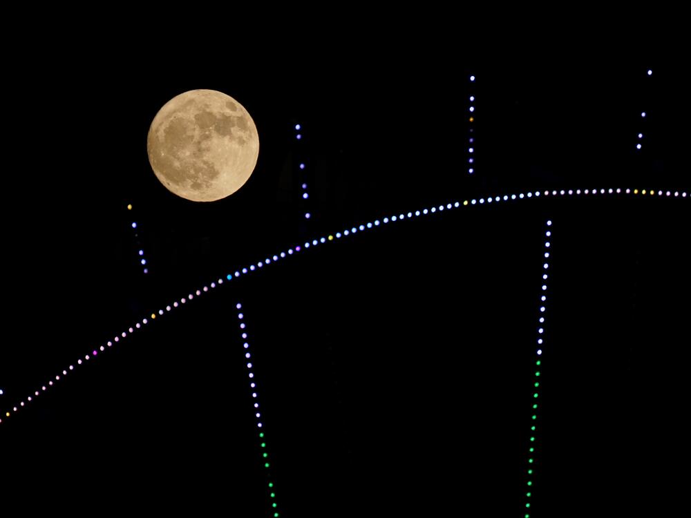 A ferris wheel is seen in front of the full moon in Duhok, Iraq on June 10, 2025.