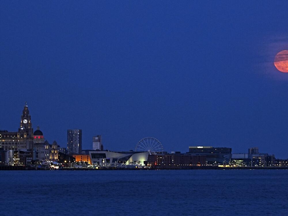 The full moon, also known as the Strawberry Moon rises over Liverpool, England.