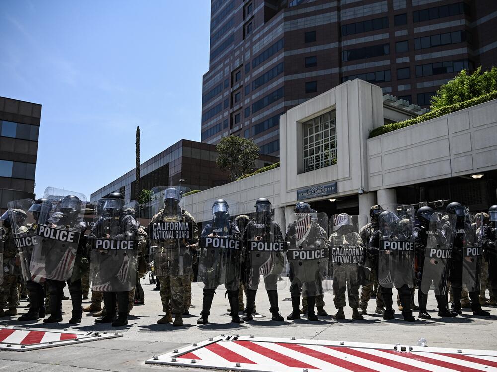 Members of the California National Guard form a line near the entrance to a federal building in downtown L.A. on Tuesday.