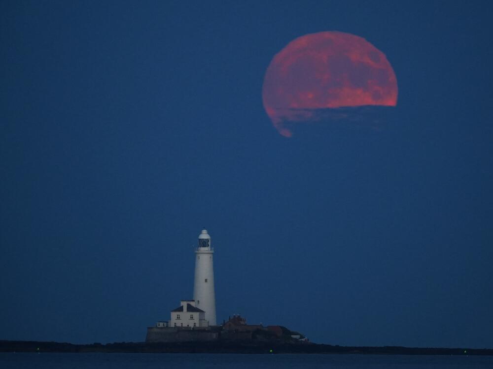 The full moon, also known as the Strawberry Moon rises over St Mary's Lighthouse in Whitley Bay.
