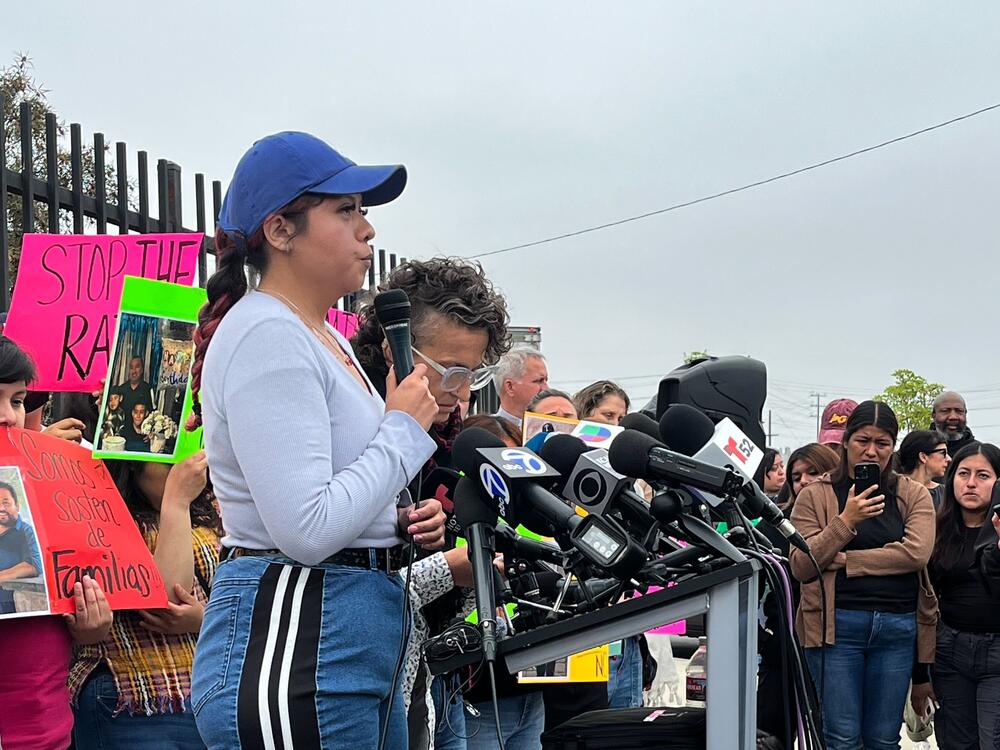 Sarai Ortiz is pictured at a rally for the detained workers on Monday. She told NPR her father, Jose Ortiz, was detained by ICE on Friday. She said her father has been in the U.S. for 30 years, and had worked his way up at Ambiance Apparel to floor manager for the last 18 years.