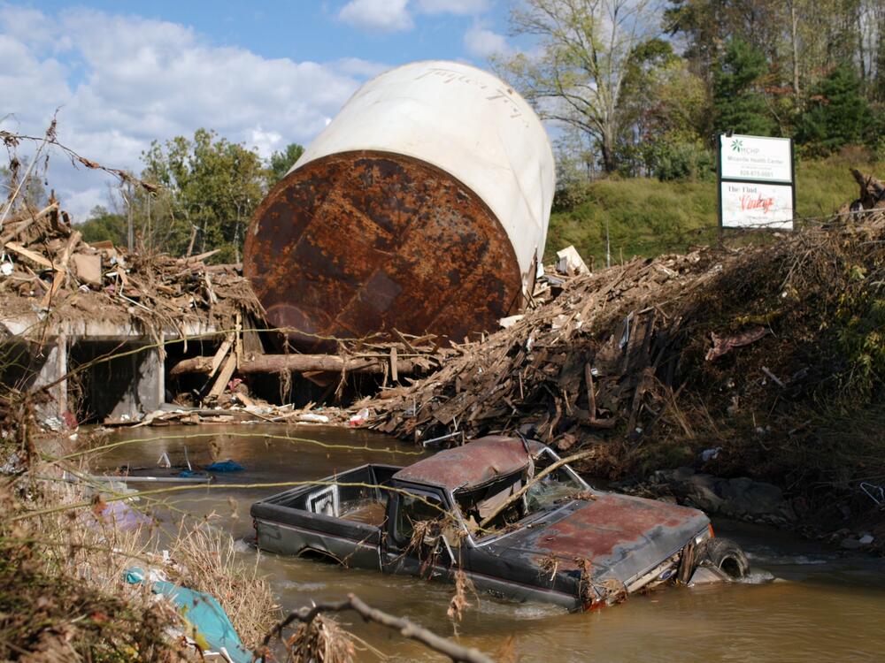 Rivers in western North Carolina overflowed their banks by as much as 26 feet. This one in Micaville, N.C. dragged trucks and debris down river.