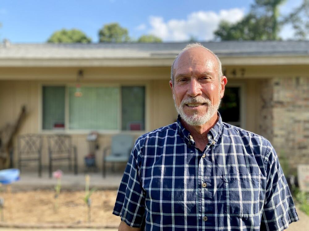 Ron Watson stands outside his Alabama home with a fortified roof. He received both a state grant and yearly insurance discount to offset the added cost.