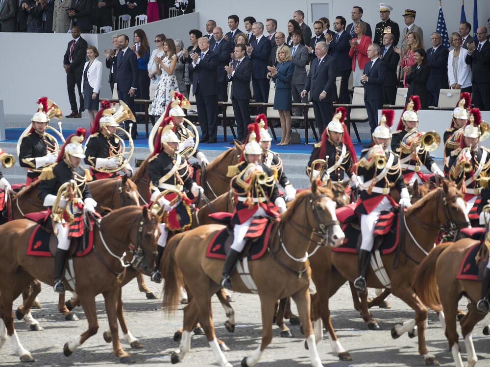 President Donald Trump, first lady Melania Trump, French President Emmanuel Macron, center, and his wife Brigitte Macron look out from the viewing stand during Bastille Day parade on the Champs Elysees avenue in Paris on July 14, 2017.