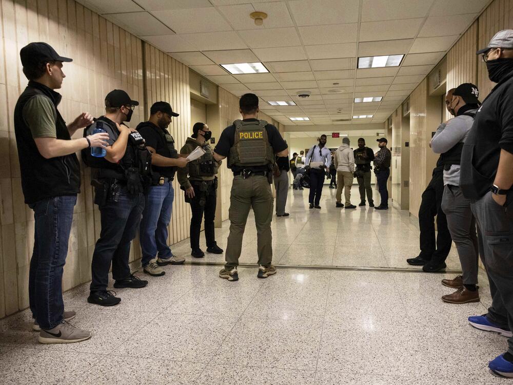 Federal agents wait outside an immigration courtroom at the Jacob K. Javits Federal Building in New York on June 10, 2025.