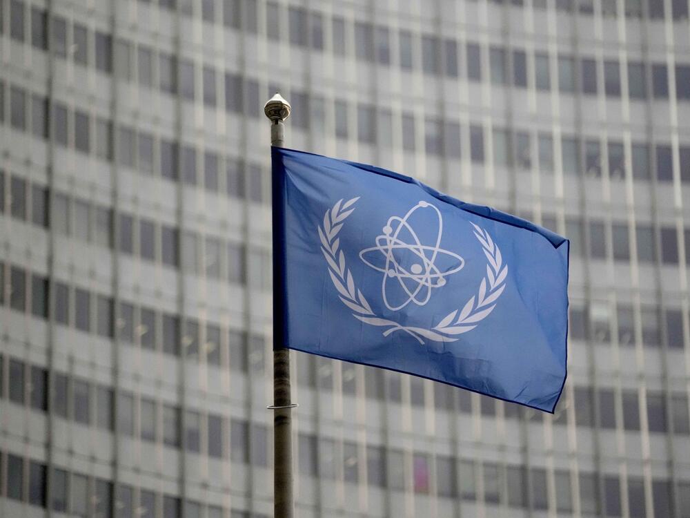 The flag of the International Atomic Energy Agency flies in front of its headquarters during an IAEA Board of Governors meeting in Vienna, Austria.