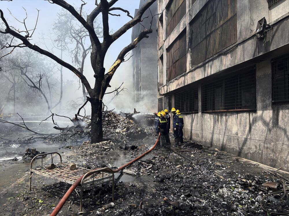 Firefighters work at the site of an airplane that crashed in India's northwestern city of Ahmedabad in Gujarat state on Thursday.