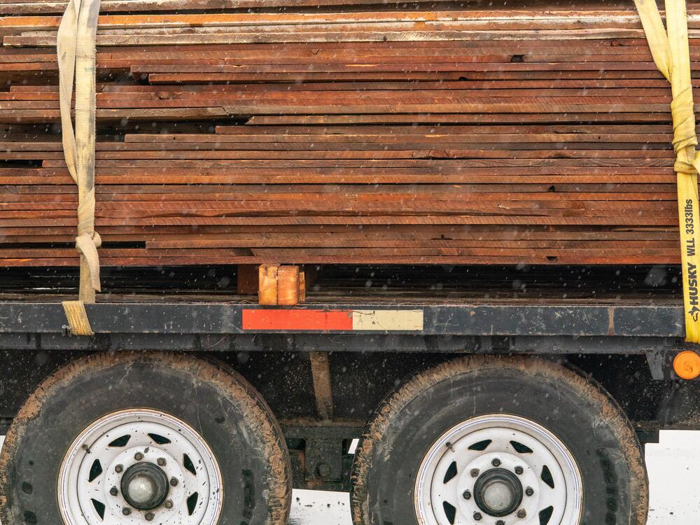 A truck is piled with planks salvaged by Perks Deconstruction from an old farmhouse in Aurora. The wood will be transported to the company's warehouse, where it will be sorted and priced for sale.