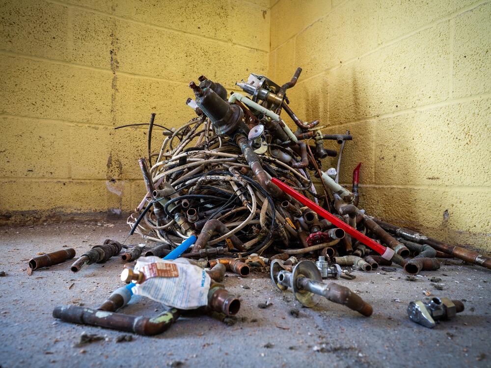 Old wiring and pipe fittings are piled in the corner of a basement at a home in Boulder, where Perks Deconstruction is taking down the home and salvaging as much of its material as possible.
