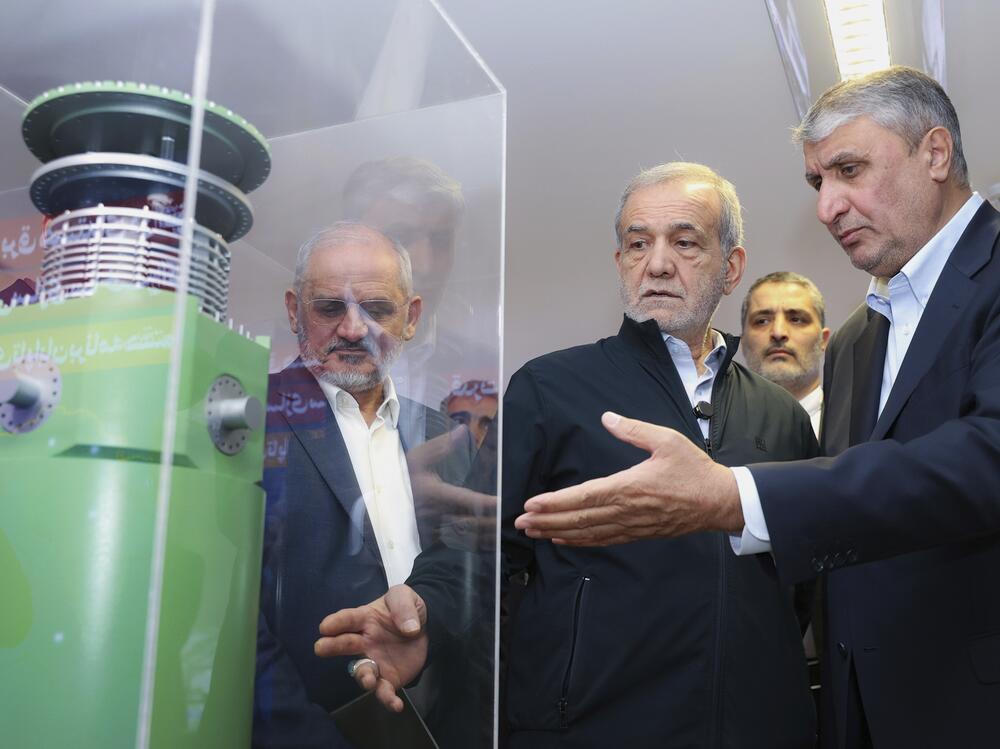 Iranian President Masoud Pezeshkian (second right) listens to the director of the Atomic Energy Organization of Iran, Mohammad Eslami, as he visits an exhibition of Iran's nuclear achievements in Tehran, Iran, April 9.
